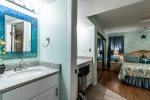 dual vanities, master bedroom suite, wood floors, blue mosaic glass mirror